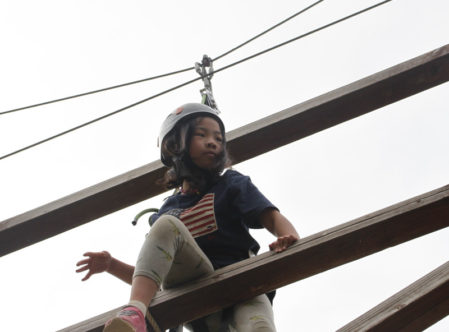 camper navigating the challenge course