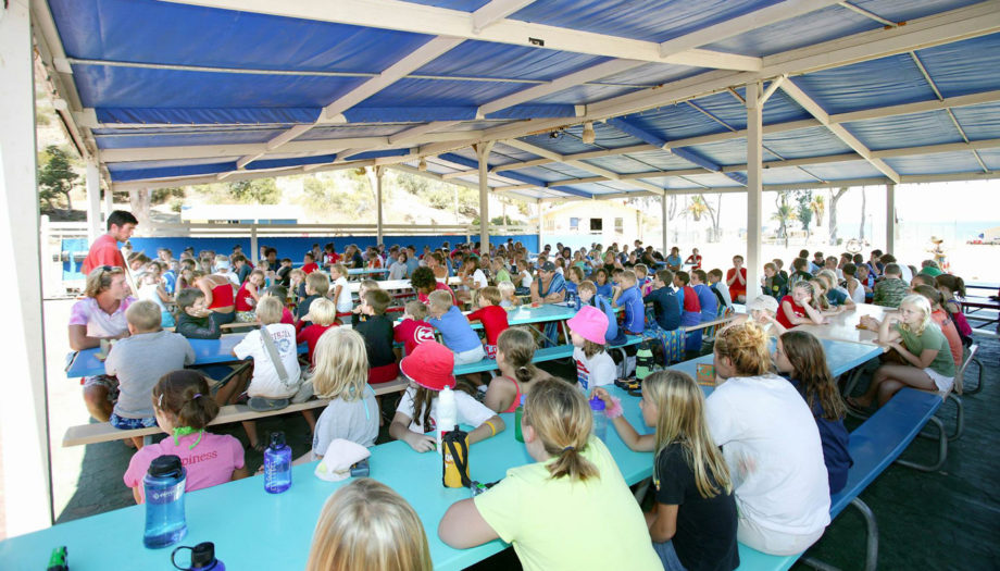 campers listening intently at the eating area