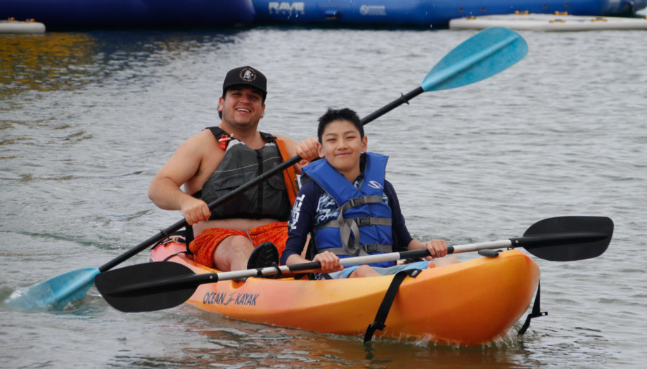 camper and counselor in a two person kayak